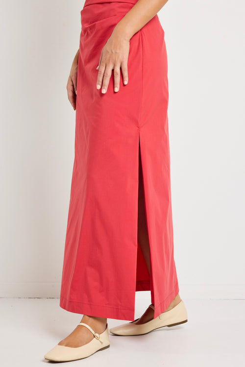 Woman wearing a bold red one-shoulder dress with flattering ruching, perfect for a glamorous night out.