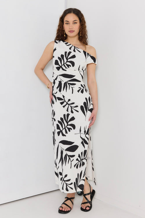 model wears a black and white maxi dress