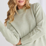 model wears a green knit