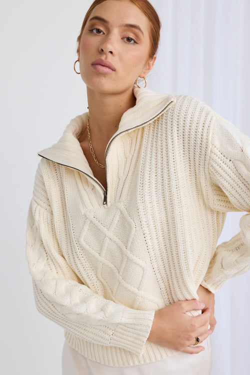 model wears a white knit jumper