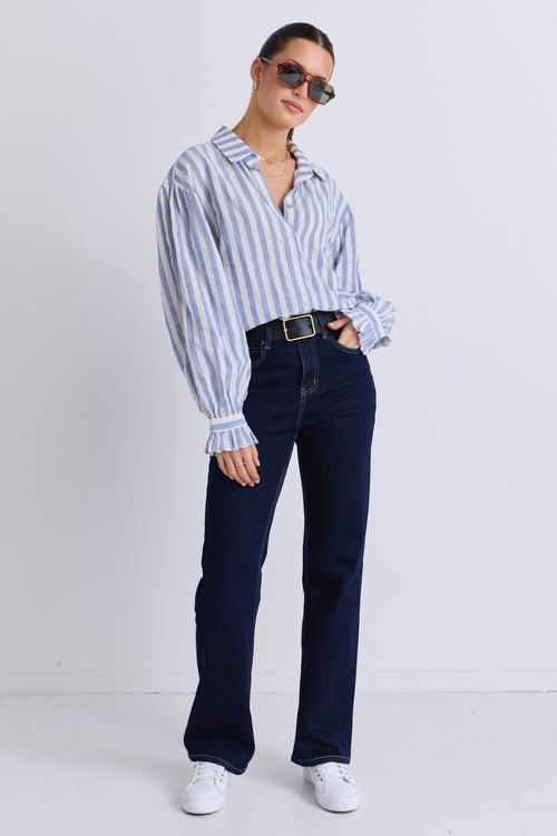 model wears a blue and white stripe shirt