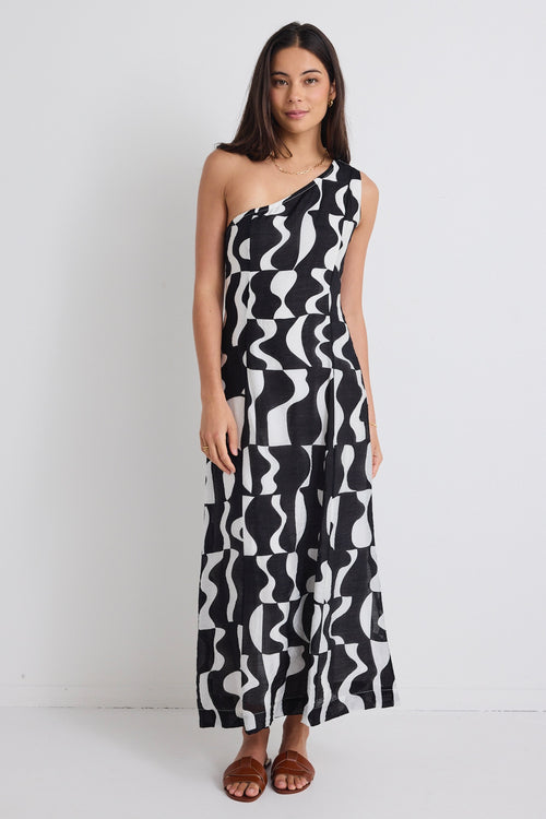 model wears a one shoulder black and white print dress