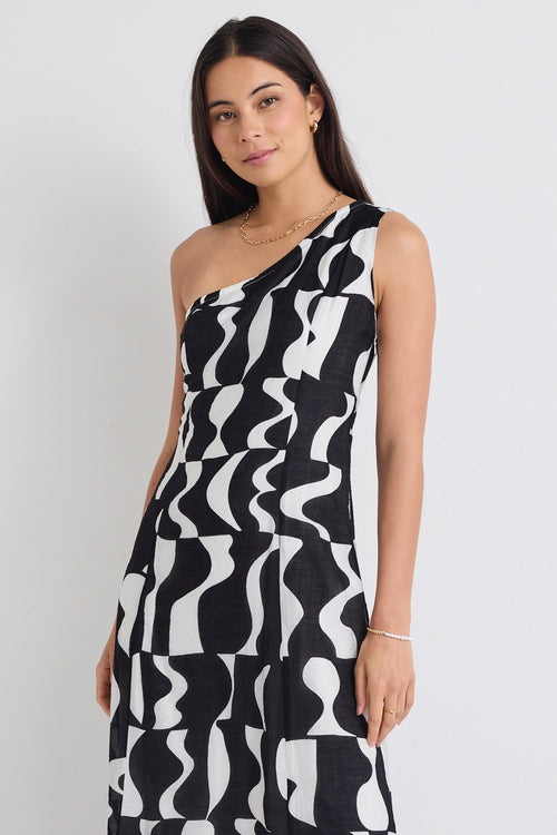 model wears a one shoulder black and white print dress