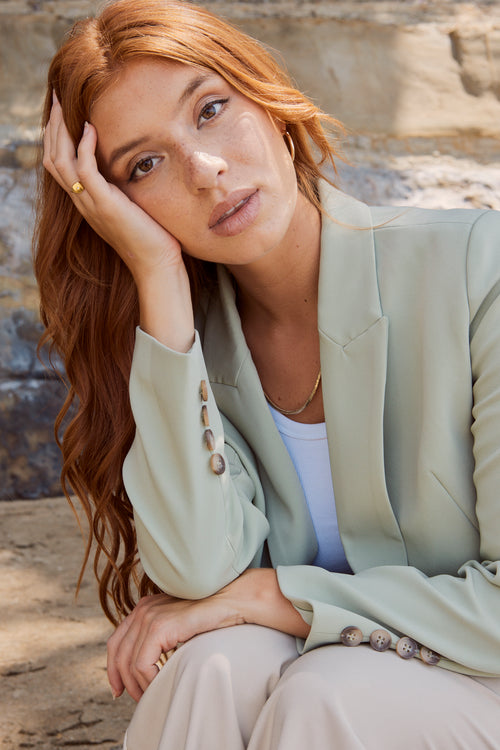 model wears a green blazer