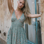 model wears a green maxi dress