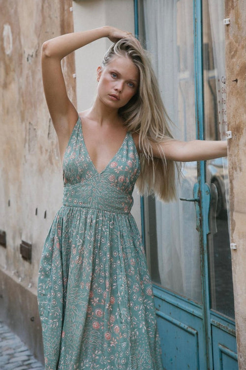 model wears a green maxi dress