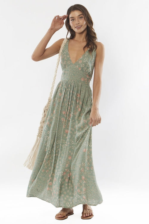 model wears a green maxi dress