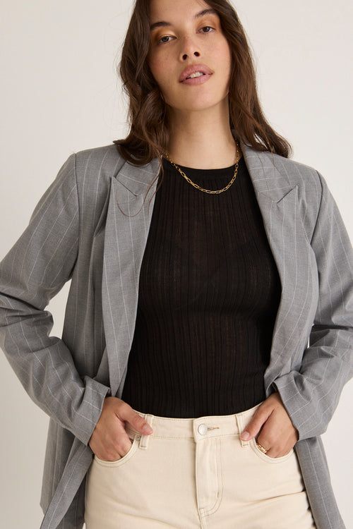 model wears a grey blazer