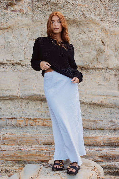 model wears white linen maxi skirt