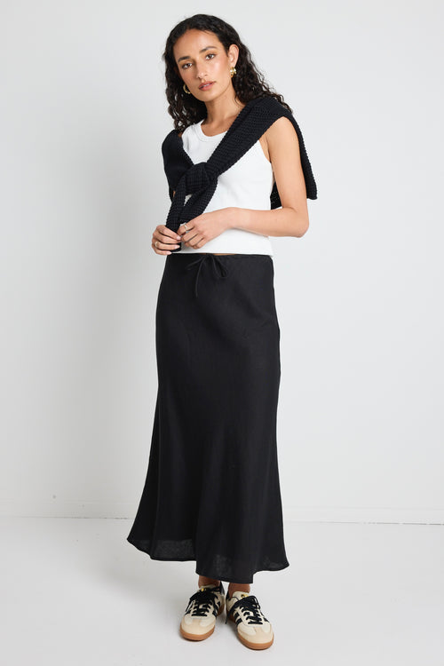 model wears a black linen maxi skirt