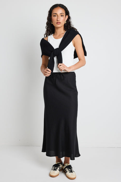 model wears a black linen maxi skirt