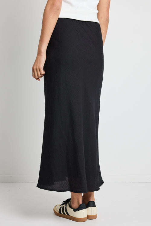 model wears a black linen maxi skirt