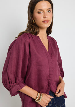 model wears burgundy blouse