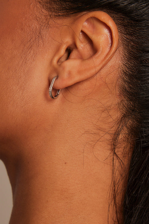 model wearing silver hoop earrings