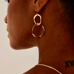 model wearing double link gold earrings