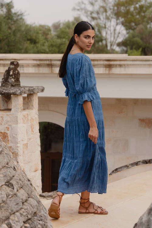 model wears a blue midi dress