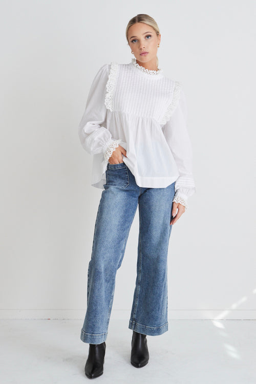 model wears a White High Neck Blouse