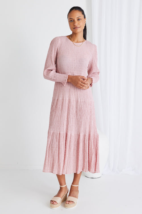 model wears a pink long sleeve dress