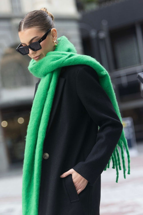 model wears a green scarf