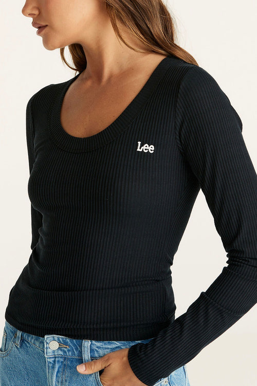 Model wears a Long Sleeve Black Top