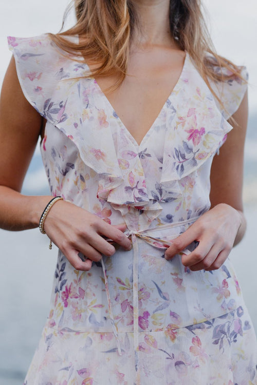 model wears a white floral maxi dress