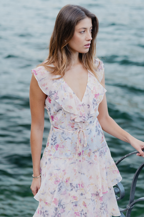 model wears a white floral maxi dress