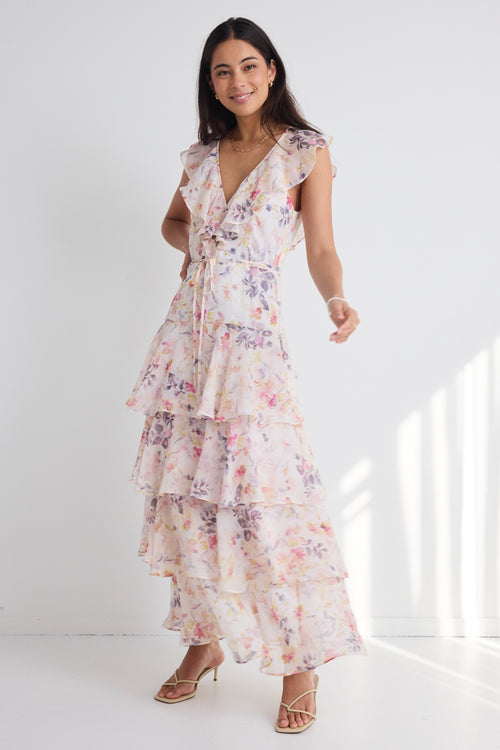 model wears a white floral maxi dress