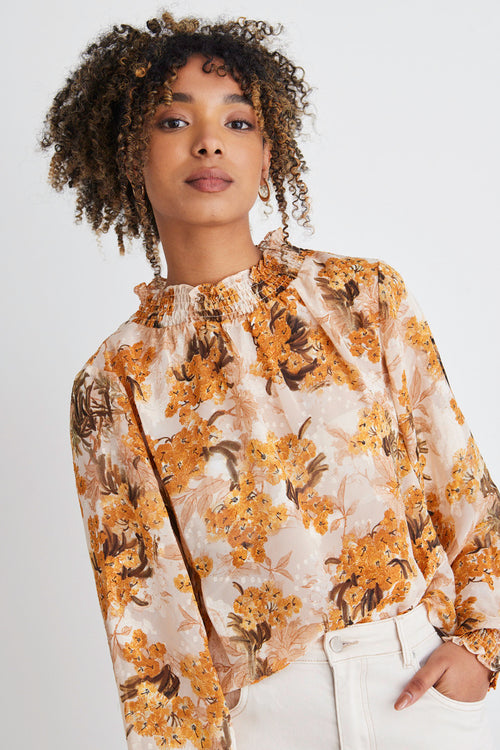 model in orange floral top