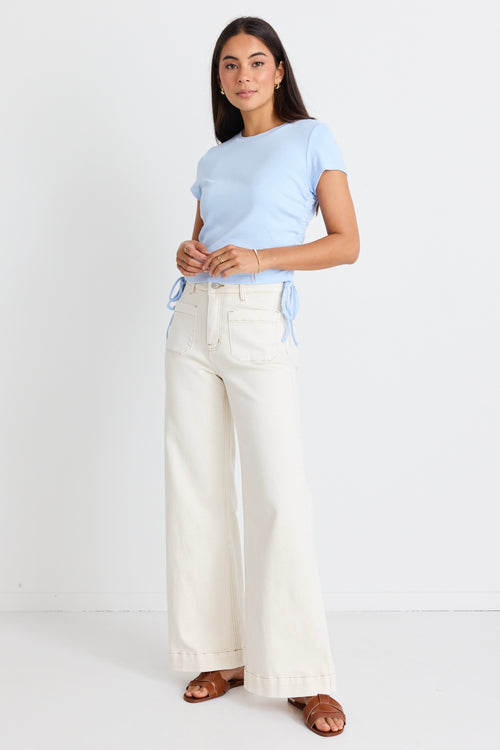 model wears white wide leg jeans