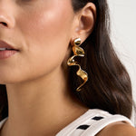 model wears gold earrings