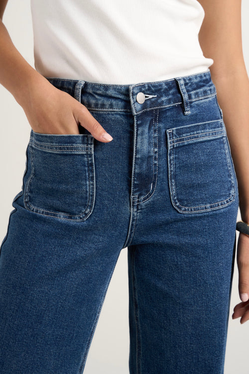 model wears a blue wide leg jean