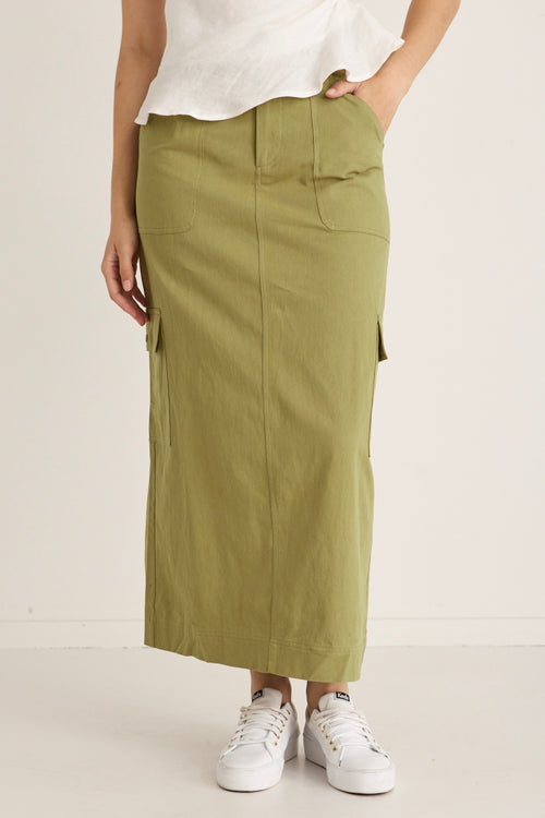 model wears a green skirt