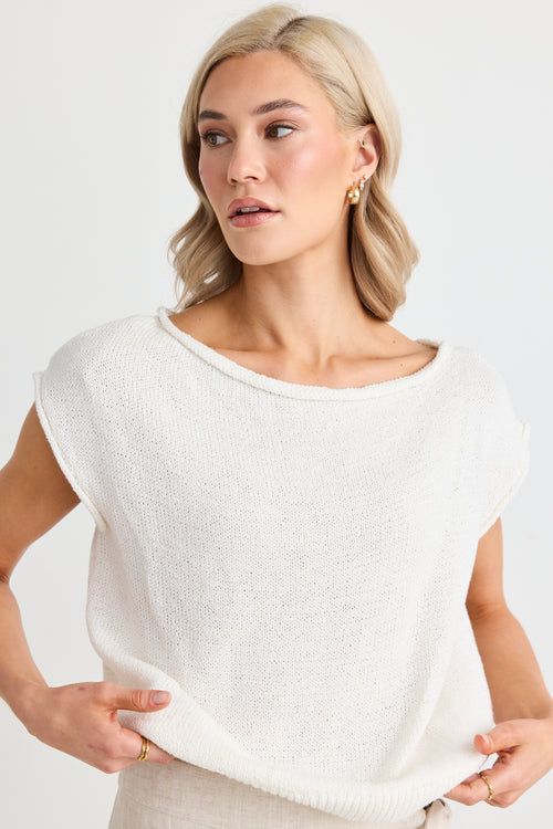 model wears a white off the shoulder top