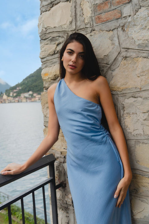 model wears a blue one shoulder midi dress