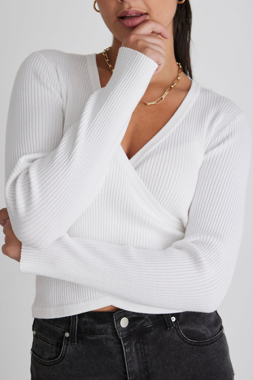 model wears a white long sleeve top