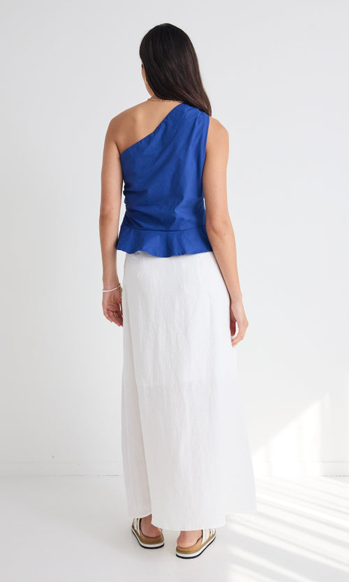 model wears white cotton linen midi skirt and blue top