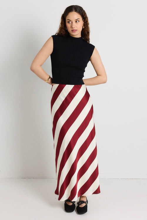 model wears a red white stripe maxi skirt