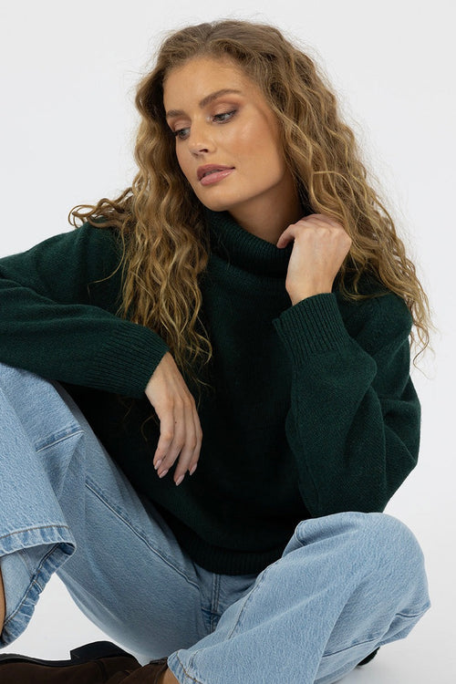 model wears a green knit jumper