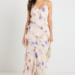 Model wears a floral cream maxi dress