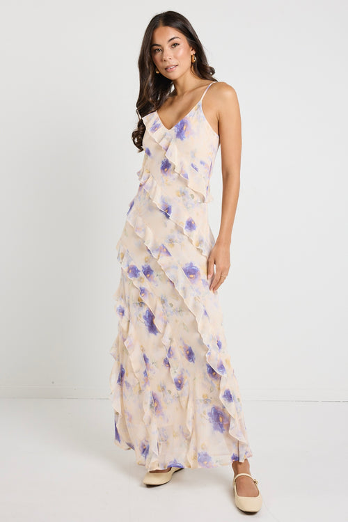 Model wears a floral cream maxi dress