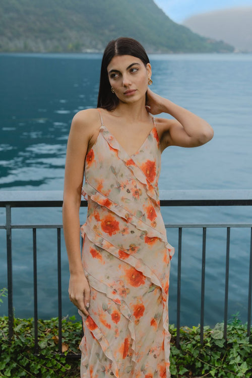 model wears orange ruffled slip dress