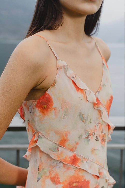 model wears orange ruffled slip dress