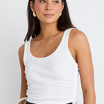 model wearing white crop tank top and black mini skirt