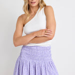 model wears a purple mini skirt