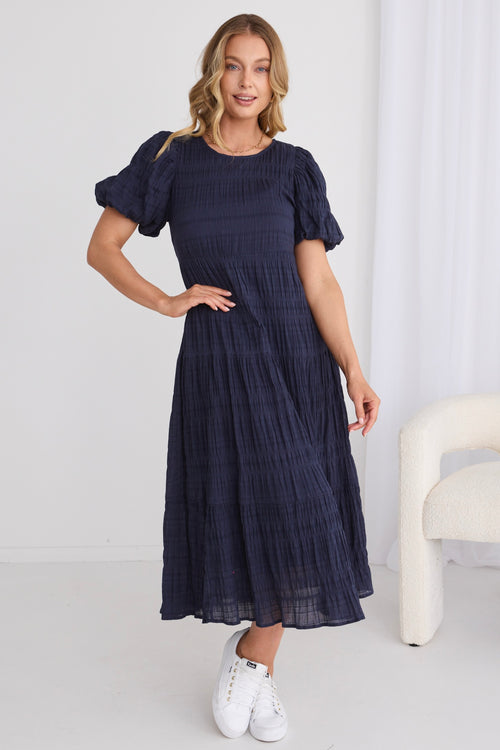 model wears a navy midi dress