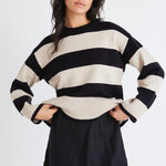 model wears a beige and black stripe knit