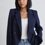 model wears a navy blue blazer