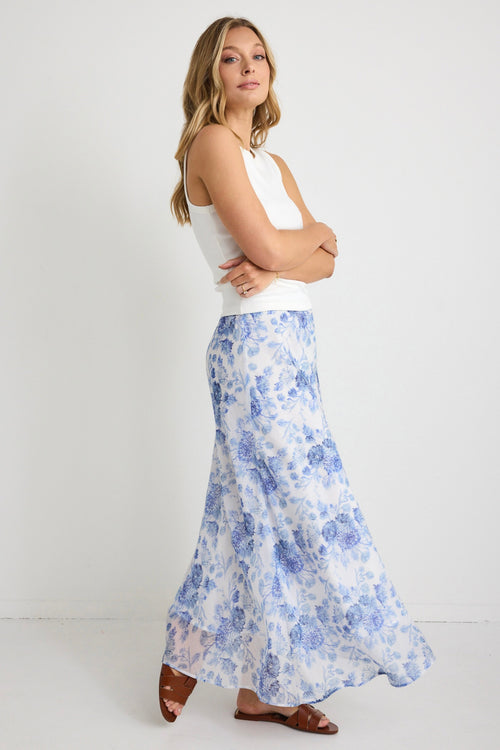 model wears a blue floral maxi skirt