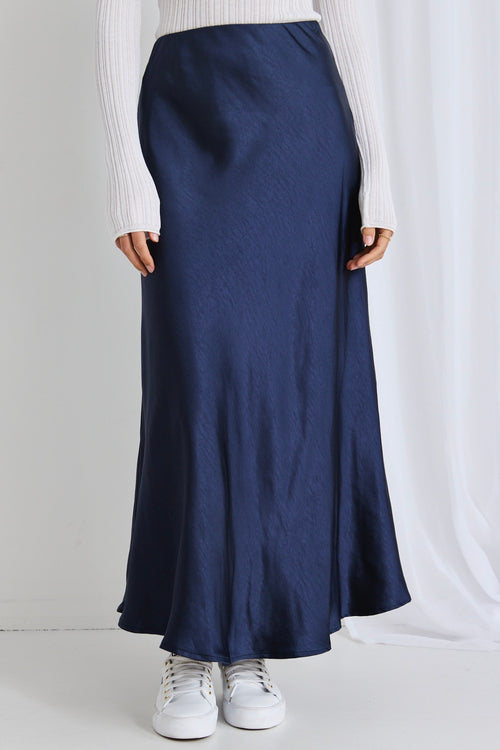 model wears a navy maxi skirt