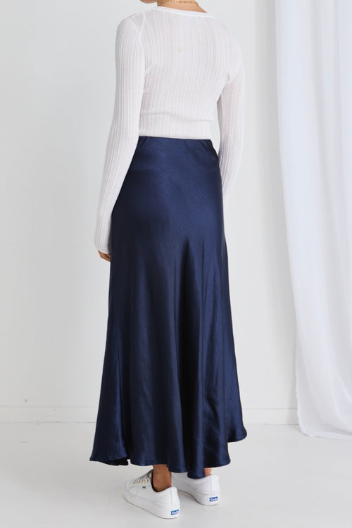 model wears a navy maxi skirt